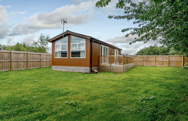 A house with a deck and fenced yard at Cherry Tree in Carlton Miniott near Thirsk