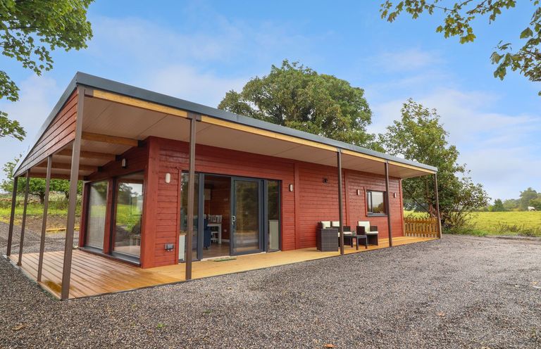 A cottage with a deck and outdoor furniture at Killinure Cottage, Glasson, County Westmeath