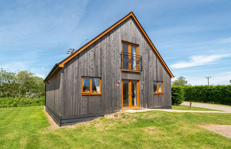 A house with windows and a balcony at Aspen Lodge Near Brigg