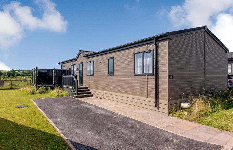 A mobile home with steps and a patio area at Scaféll (Pet) in Penrith