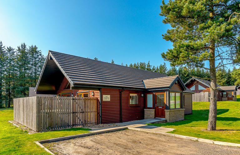 A house with a path and trees at Raeburn Premier Spa in Dundee