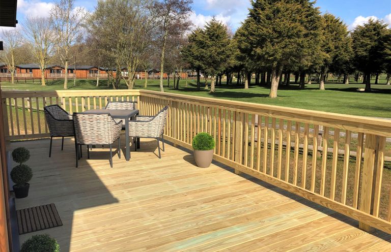 A deck with a table and chairs at Dream View in Waltham