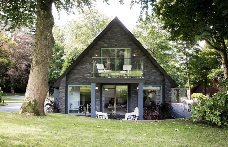 A house with a balcony and deck at St Austell Lodge Spa in Praze-An-Beeble
