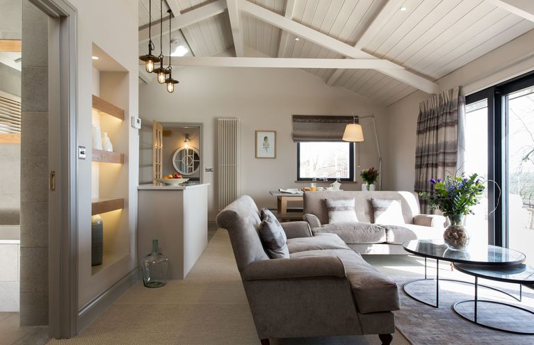 A living room with a sofa and coffee table at Dylan Spa in Laugharne