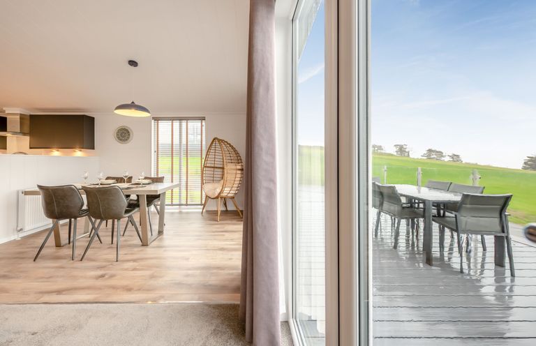 A dining room with a table and chairs at Sonnet 2 Spa in Laugharne