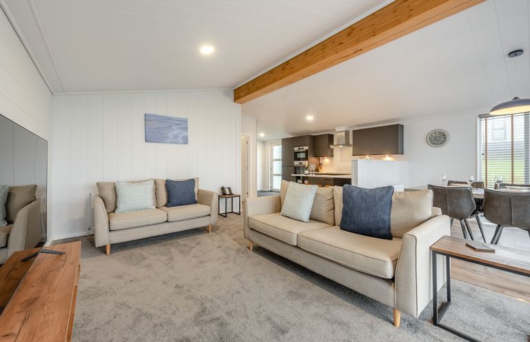 A living room with sofa and coffee table at Sonnet 3 in Laugharne