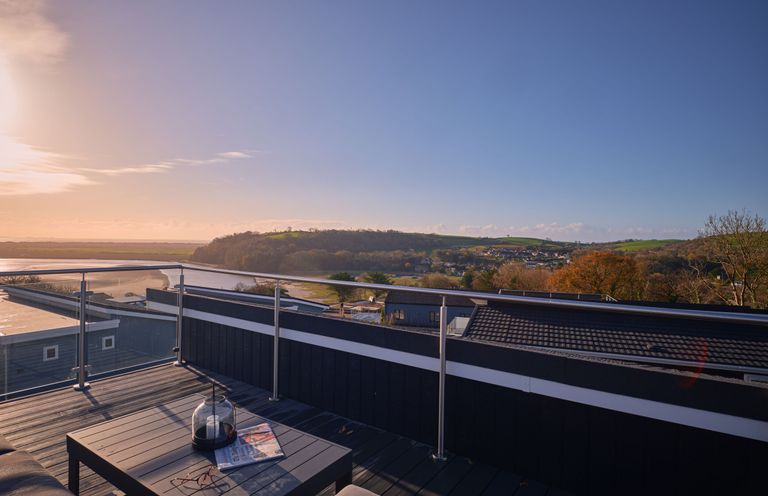 A roof terrace with a table and view at Epic Spa (Roof Terrace) (Pet) in Laugharne