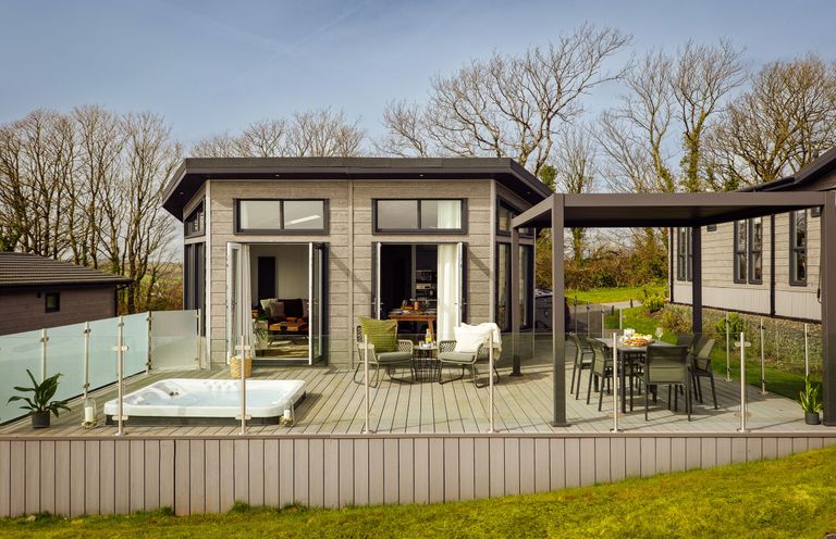A deck with hot tub and seating area at Apex Spa (Pet) in Laugharne