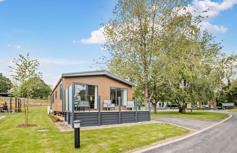 A cabin with decking and furniture in an outdoor area at Saron 2.0 Pet in Llandyrnog