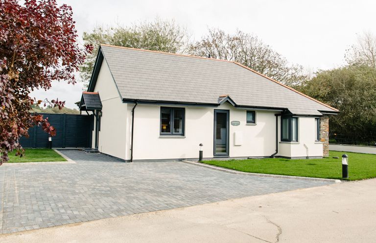A house with a driveway and garden at Cornish Lodge Spa in Bude