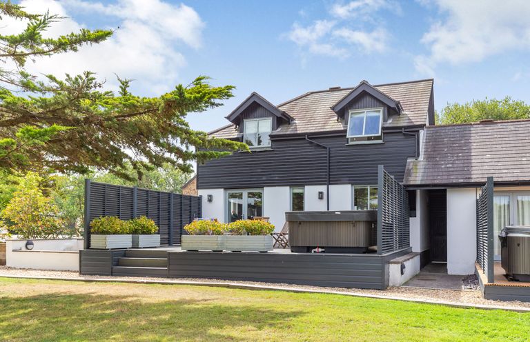 An outdoor area with a deck and hot tub at Summerleaze Garden Cottage 3 Spa, Bude