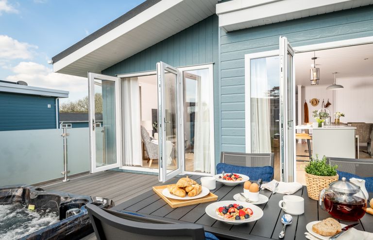An outdoor dining area with breakfast items at Sennen 3 Spa (Pet) Bude