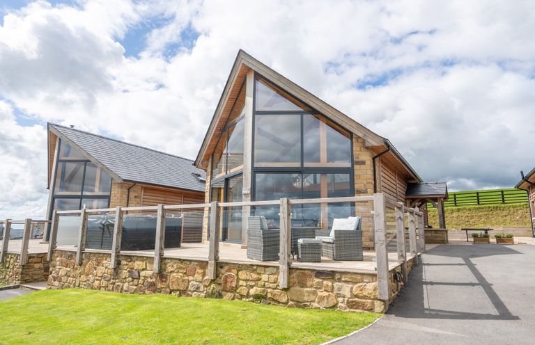 A building with large windows and a deck at Valley View Lodge 1 Preston