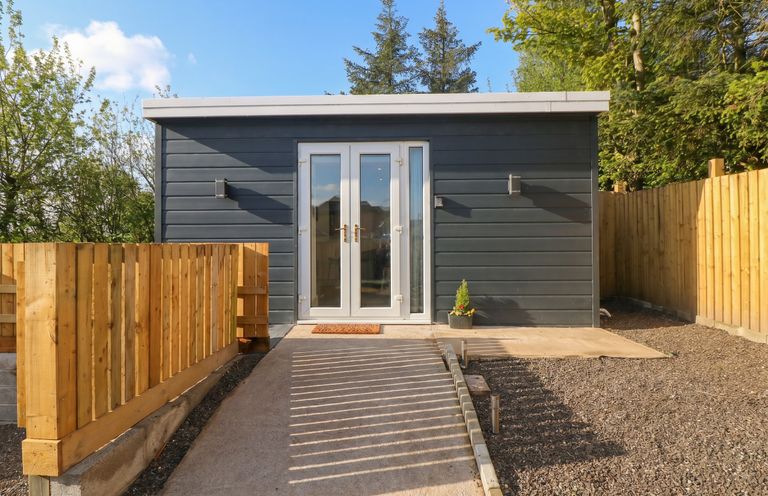An outdoor view of a cabin entrance at Heidiaway Lodge in Gilfach Goch