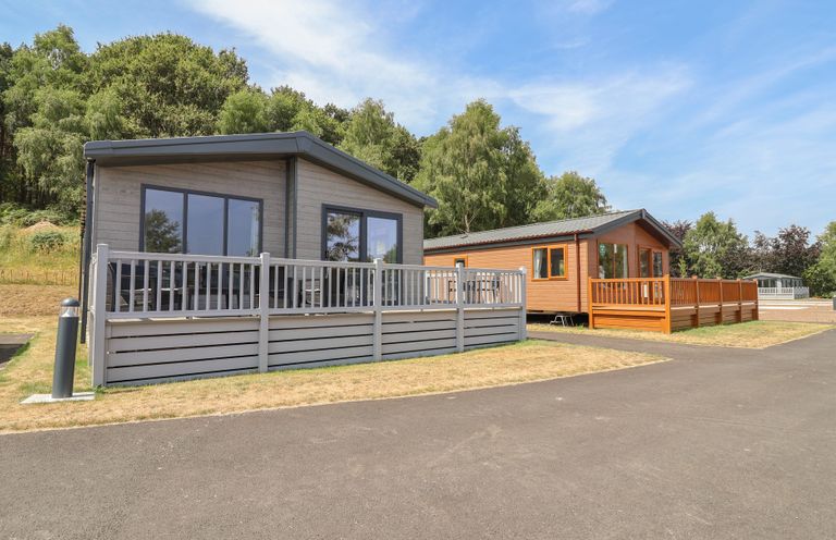 Two cabins with decks in a natural setting at Cedar Lodge 3 Bedrooms with hot tub Delamere