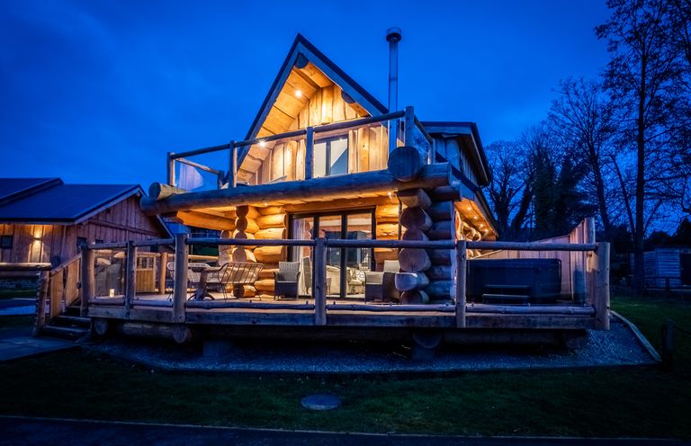 A log cabin with a deck and chairs at The Lookout in Addingham