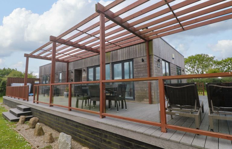 A decking area with outdoor furniture at Pentewan - 67 Portreath