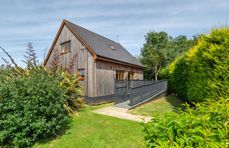 A house with a deck and garden at James Ville Marina Lodge 10 in Brigg