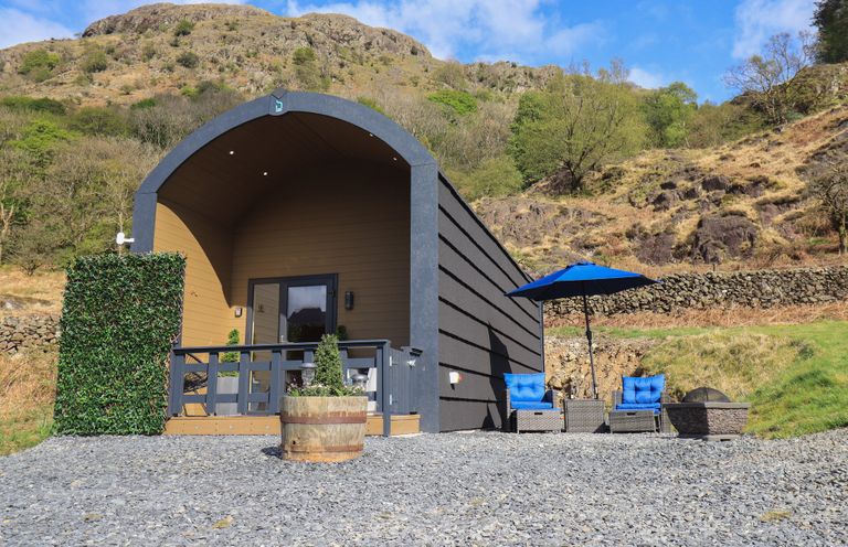 An outdoor cabin with a deck and seating area at Bluebelle - Crossgate Luxury Glamping Hartsop