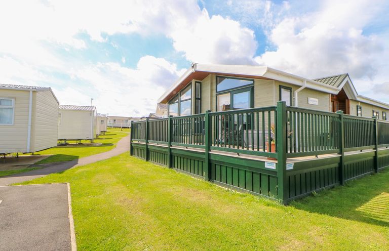 A park home with decking and grass area at 37 Horizon Park in Hartlepool