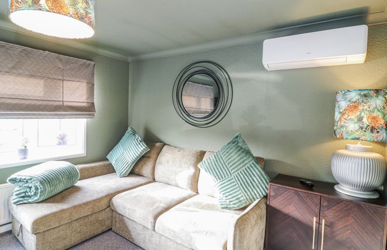A living room with a sofa and lamp at The Nest Lodge 55 Grantham