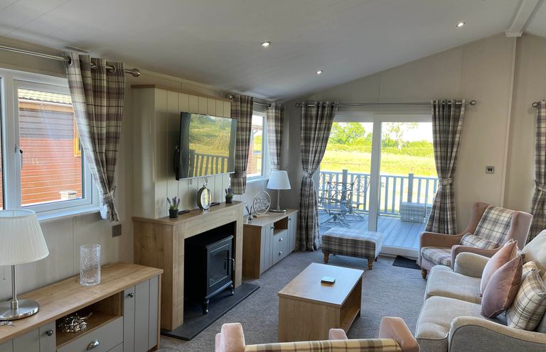 A living room with a television and seating area at Yorkshire View Lodge in Wilberfoss