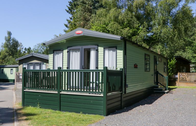 A green caravan with a deck at 51 Calgarth Park in Troutbeck