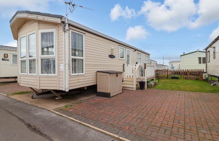 A caravan with steps and a fenced garden at Winchester - 478 Abergele