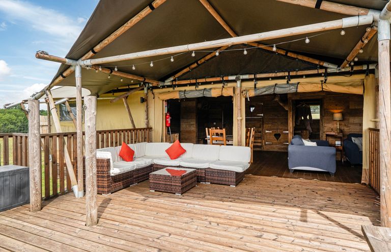 An outdoor seating area with a sofa and coffee table at Luxury Safari Lodge Sleeps 4/6 Deer Park Dogs Ok Zeal Monachorum near Bow