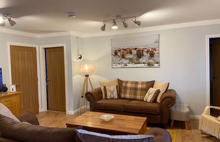 A living room featuring a sofa, coffee table, and wall art at Blairgowrie Luxury 3 Bed Lodge with Hot Tub in Blairgowrie