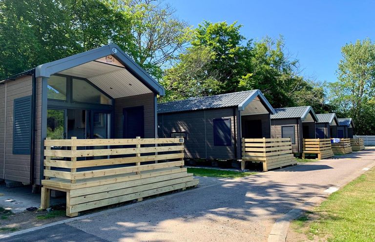 A row of cabins with wooden decking and a pathway at Selfcatering Lodge Inverness Sleeps 4 Inverness