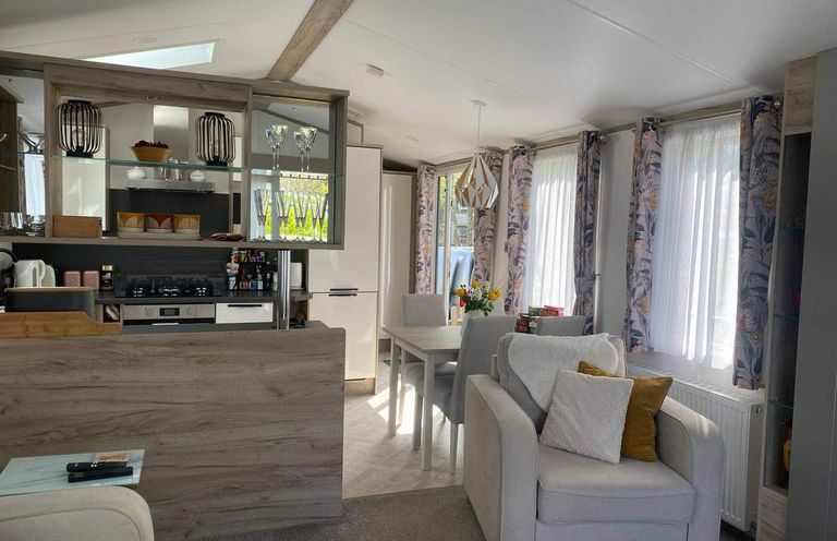 A kitchen and dining area with seating at Findhorn Lodge Peaceful Sleeps 4 in Forres