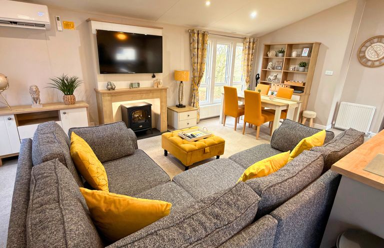 A living room with a sofa and television at Meadows 33 Hot tub Southview Holiday Park in Skegness