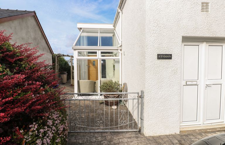 An outdoor area with a gate and door at Hafan y Tyddyn