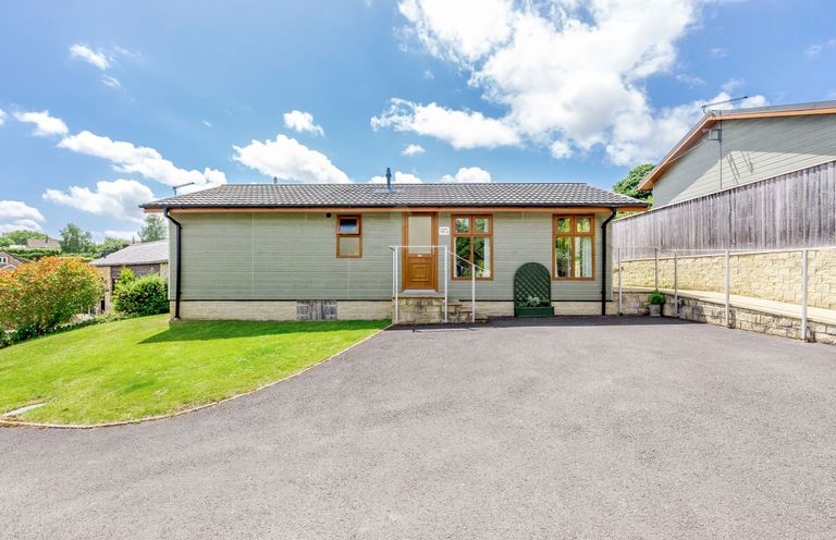 A single-story house with a tiled roof lawn and paved driveway at Lavender Lodge in Charlton Horethorne near Sherborne