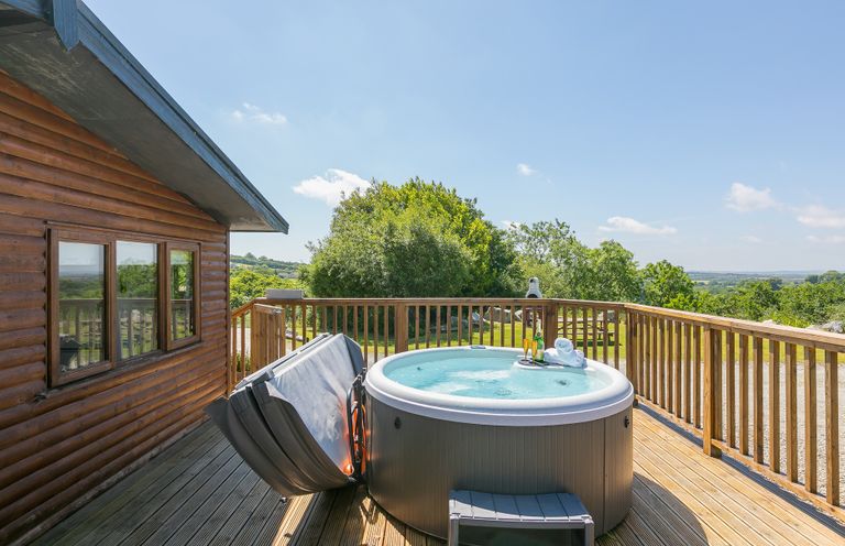 A hot tub on a deck with a view at Costentyn, Tor Down Quarry, St Breward